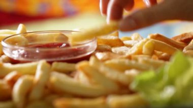 Kadın el patates kızartması arka plan bulanık ketçap daldırma alarak yakın çekim