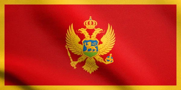 Montenegró zászlaja szövet-textúrával integetett — Stock Fotó