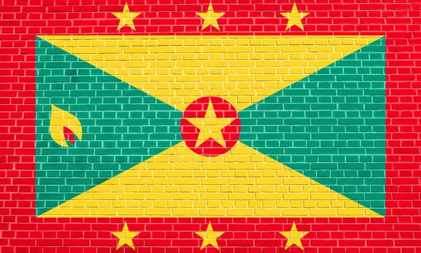 Vlag van Grenada op bakstenen muur textuur achtergrond — Stockfoto