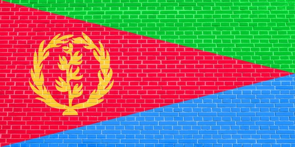 Eritrea zászlaja a téglafalak textúráját jelző háttérrel — Stock Fotó
