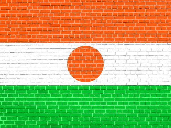 Bandeira de Niger no fundo textura parede de tijolo — Fotografia de Stock