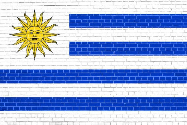 レンガの壁のテクスチャの背景にウルグアイの旗 — ストック写真
