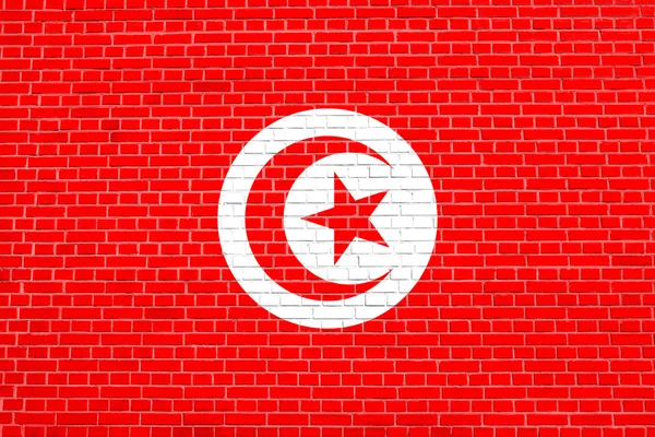Flaga Tunezji na tle cegły ścianie tekstury — Zdjęcie stockowe