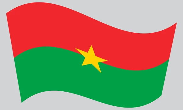 Burkina Faso a hullámzó zászlaja szürke háttér — Stock Vector