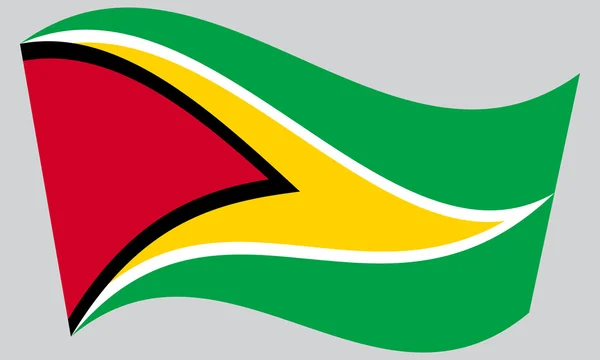 Bandera de Guyana ondeando sobre fondo gris — Vector de stock