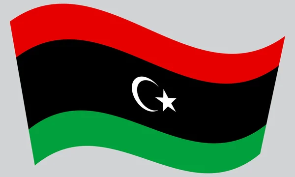 Flag of Libya waving on gray background — ストックベクタ