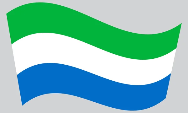 Flag of Sierra Leone waving on gray background — ストックベクタ