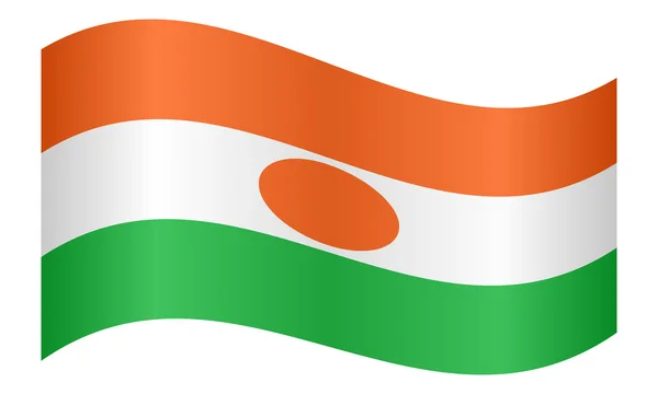 Flag of Niger waving on white background — Stock vektor