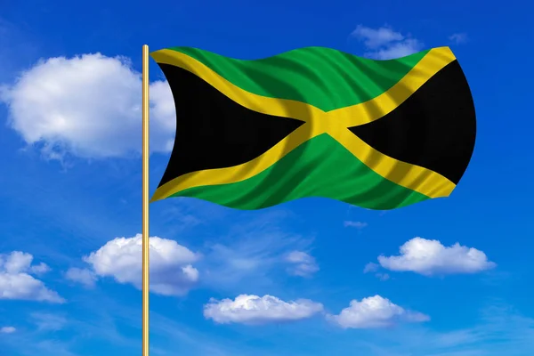 Flag of Jamaica waving on blue sky background — Stock Photo, Image