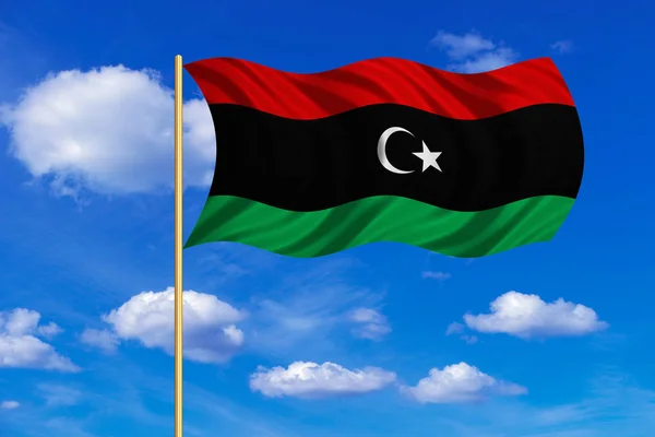 Flag of Libya waving on blue sky background — Stock Photo, Image