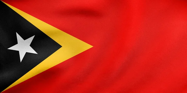 Vlag van Oost-Timor zwaaien, echte textuur van de stof — Stockfoto