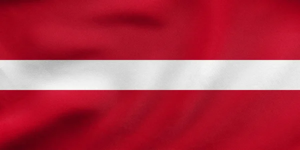 Bandiera della Lettonia sventola, tessitura in tessuto reale — Foto Stock