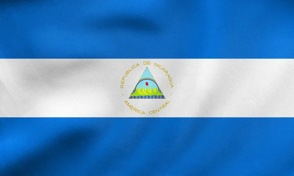 Σημαία της Νικαράγουας κυματισμού, πραγματική υφή υφάσματος — Φωτογραφία Αρχείου