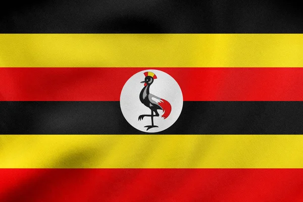 Vlajka Ugandy mává, skutečné textilie textura — Stock fotografie