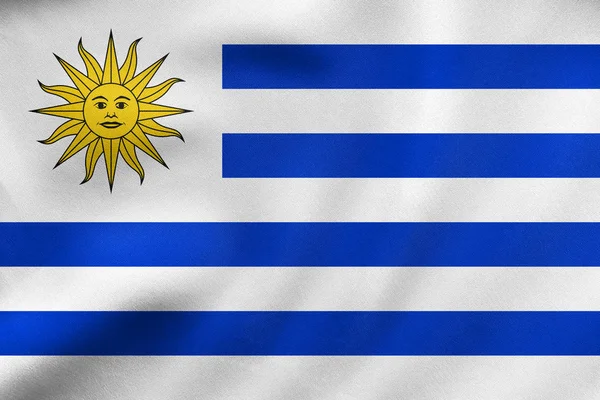 Bandiera di Uruguay sventola, tessitura in tessuto reale — Foto Stock