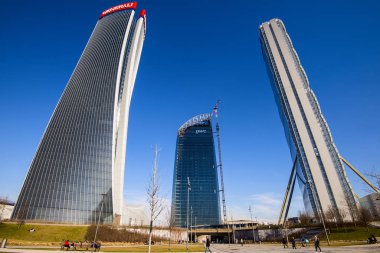 MILAN, ITALY - JANUARY 31, 2020: Three tower skyscrapers Generali Hadid Tower, Allianz Isozaki Tower and PWC Libeskind Tower under construction in Milan at CityLife district area. clipart