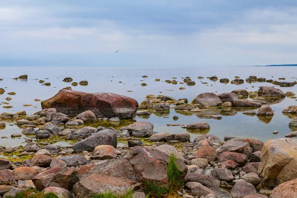 Beautiful cloudy landscape of rocky sea shore. Tranquil scene of Baltic sea.