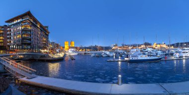OSLO, NORWAY - 27 FEB 2016: Panoramic view of marina with Akershus Fortress and City hall clipart