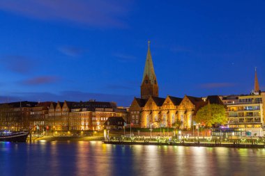 Bremen, Almanya - 16 Nisan 2016: Cityscape Weser Nehri gece eski şehrin