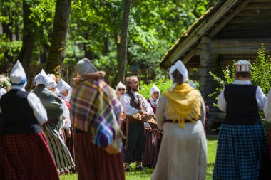Riga, Letonya - 12 Haziran 2016: Letonyalılar Ulusal kostümleri folklor şarkıları söyleyerek. Letonca Etnografya Müzesi.