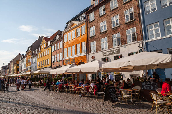 COPENHAGEN, DENMARK - 25 JUN 2016: Nyhavn canal is full of people at sunny day