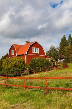 Typical scandinavian wooden houses in village. Dalarna county, Sweden. clipart