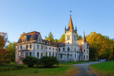 Old fairy-tale palace in Stameriena, Latvia. Fall time, bright colors at sunset clipart