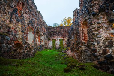 Ortaçağ taş granit Kalesi Sonbahar zaman yok eder. Sonbahar yaprakları. Rauna, Letonya