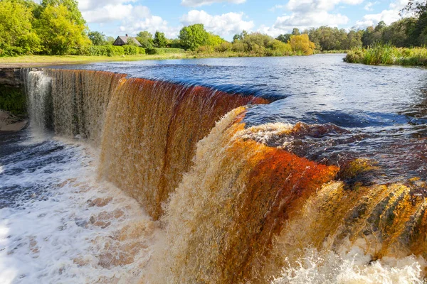 Jagala is the biggest waterfall in Estonia. Long exposure day shot. Close up. Water is red due to swamp organics.