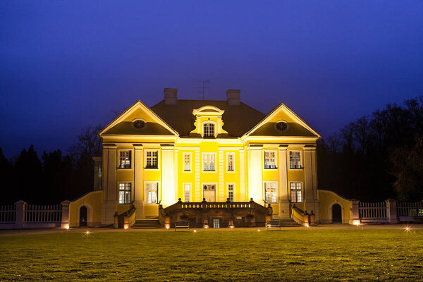 Night illuminated view of Palmse manor, Estonia. Luxury villa, park and information center.