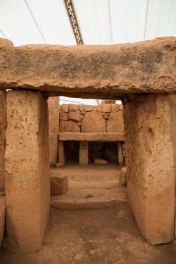 MNAJDRA, MALTA - OCTOBER 16, 2016: Prehistoric temple, megalithic landmark of Malta island. Inside view. clipart