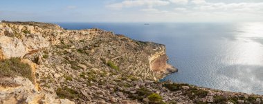 Malta adasının kireçtaşı kayaları ve gök mavisi denizi. Panoramik görünüm.