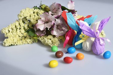 Çiçek, Paskalya tavşanları ve şekerler izole beyaz zemin üzerine