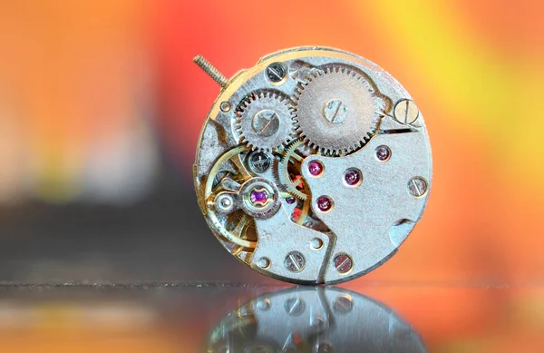 close up shot of watch mechanism with dramatic background