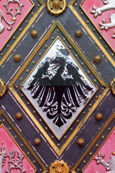 Wooden door with emblems — Stock Photo, Image
