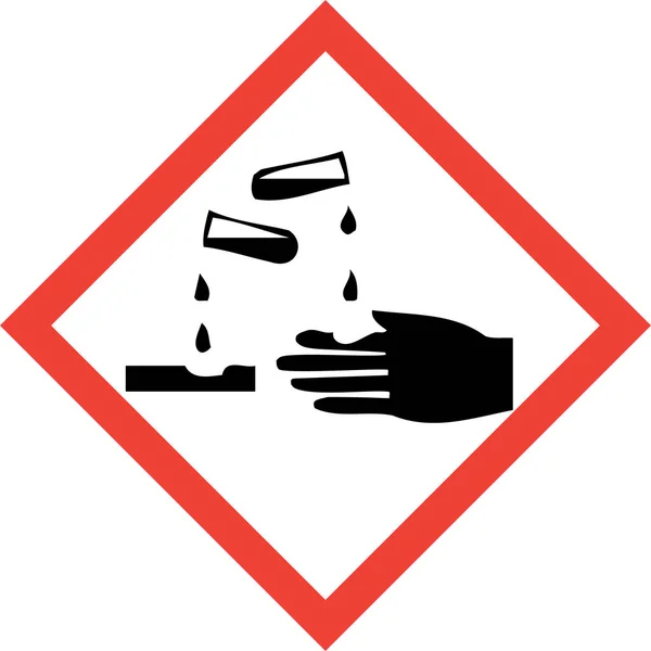 Znak zagrożenia substancjami żrącymi — Zdjęcie stockowe