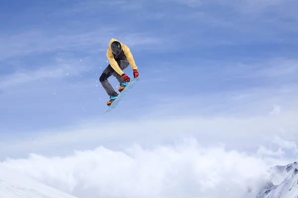 Snowboarder jumping in mountains, extreme sport. — Stockfoto