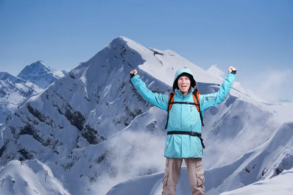 Šťastný muž horolezec s rukama nad hlavou. Na pozadí vysokých horách. — Stock fotografie