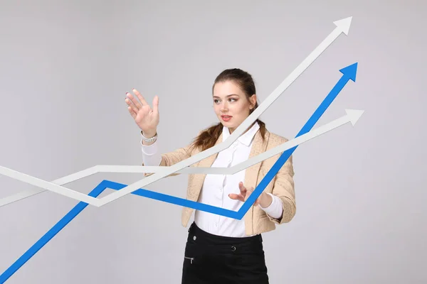 Businesswoman working with growth graph on grey background — Stock Photo, Image