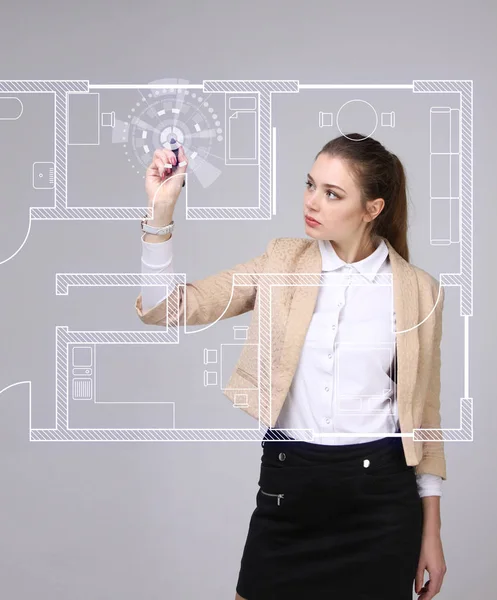 Female architect working with a virtual apartment plan — Stock Photo, Image
