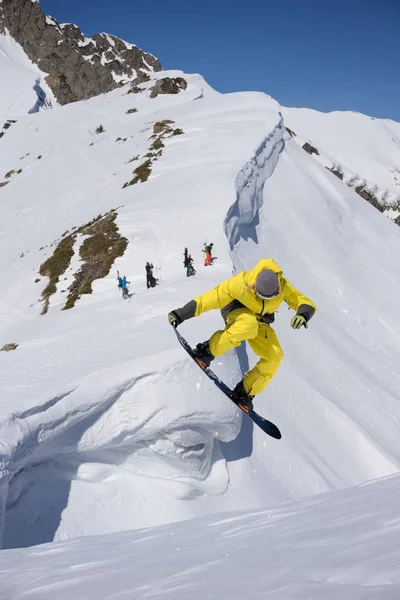 Extrema vintersport. Snowboardåkare hoppning i snötäckta berg. — Stockfoto