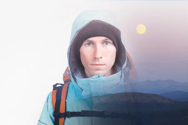Face of young man hiker and evening hilly landscape with moon. Double exposure effect photography with copy space.
