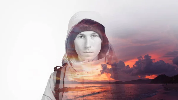 Face of young man hiker and amazing sea sunset. Double exposure effect photography.