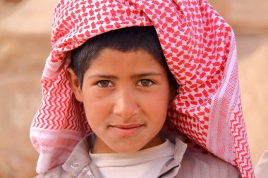 PALMYRA, SYRIA - APRIL 28, 2010: Portrait of a bedouin little boy at the archaeological site of Palmyra clipart