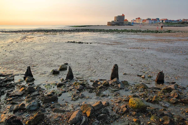 Plaży w Ambleteuse na zachód słońca, kolorowe kamienie na pierwszym planie i fort w tle, Cote d'Opale, Pas de Calais, Hauts de France — Zdjęcie stockowe