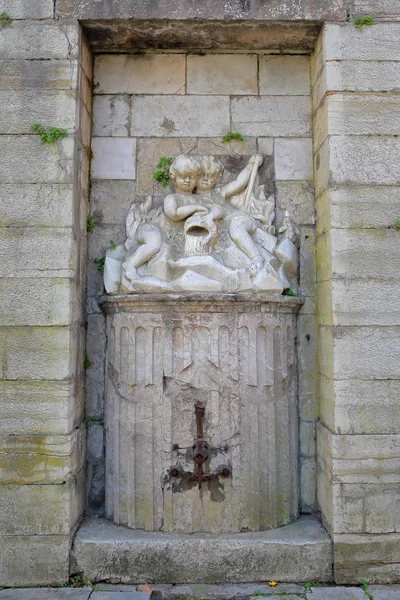 An old fountain with a statue of twins in Boulogne sur Mer, Cote d'Opale, Pas de Calais, Hauts de France — Stok fotoğraf