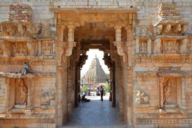 CHITTORGARH, RAJASTHAN, INDIA - DECEMBER 12, 2017: Mahasati Gate located inside the fort (Garh) of Chittorgarh, with Samideshwar Hindu Temple in the background clipart