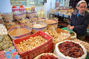 SFAX, TUNISIA - DECEMBER 24, 2019: colorful stalls of spices and pulses in the souk inside the medina of Sfax
