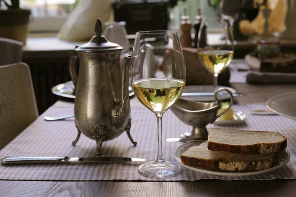 white wine, vintage teapot and some bread