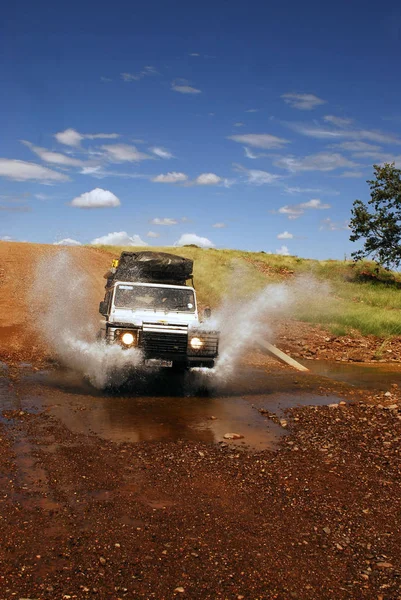 SUV during the safari in South Africa. spray of water — Stock Photo, Image